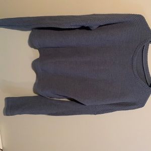 A waffle knit sweater, drop shoulder design.